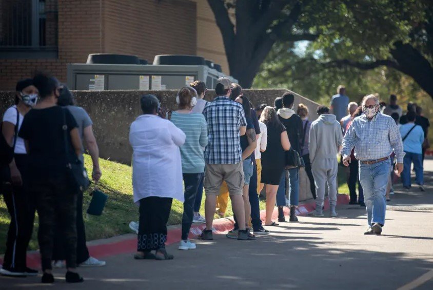 People waited in line to vote in Dallas on Tuesday, the first day of early voting.